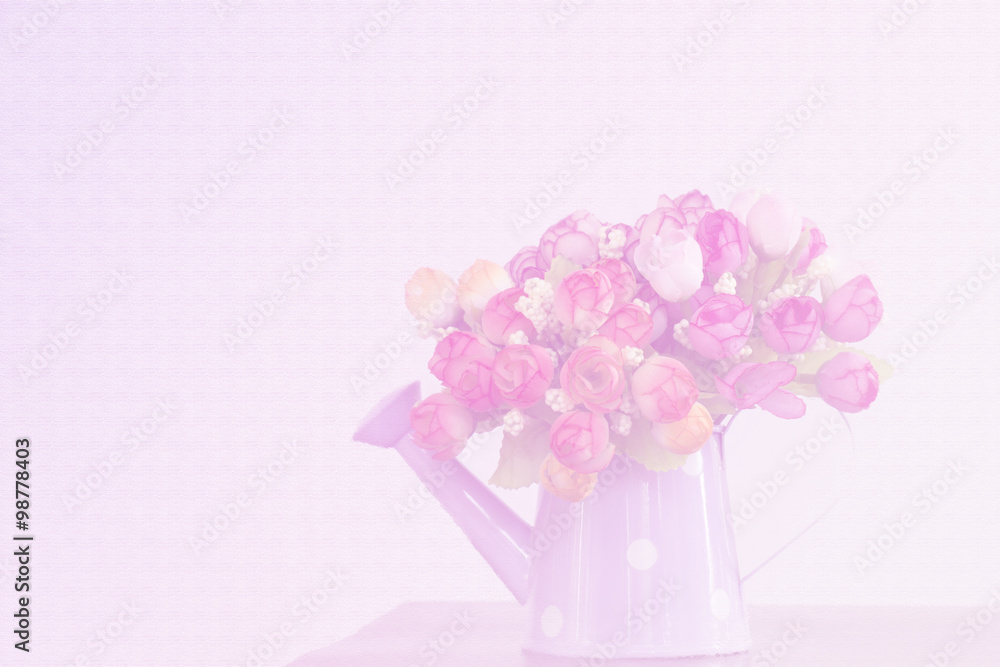 Artificial flowers in watering can. Soft color background Artificial flowers in watering can. Soft color background
