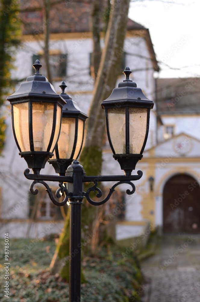 romantic lamps in front of an old small castle