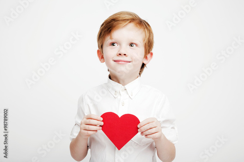 cute little boy with a red heart in the hands