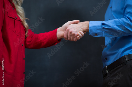 business couple shaking hands at the office