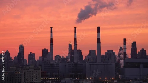 Fumes Coming out of Power Plant Chimneys in Queens and Highrises of Manhattan as Seen from Long Island City at Sunset (New York City) photo