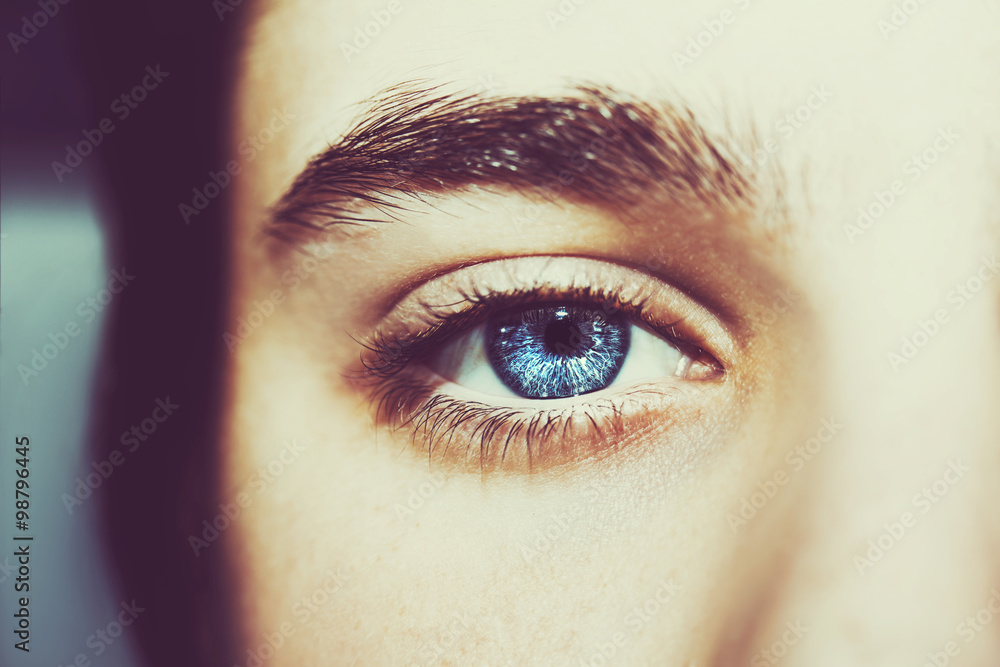 Naklejka premium An insightful beautiful look boy's blue eye