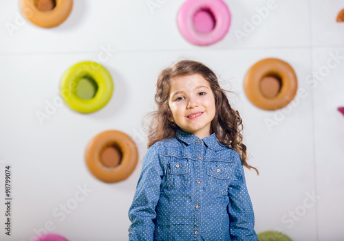 The little girl posing in a playroom photo