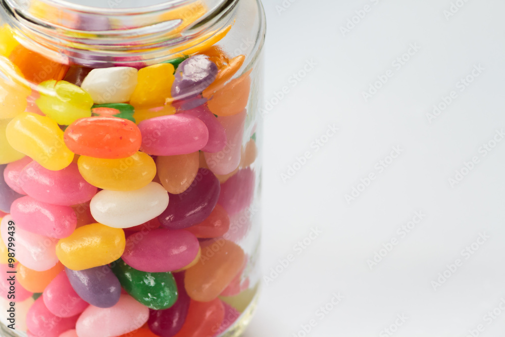 Jelly beans in glass jar on white background Jelly beans in glass jar on white background