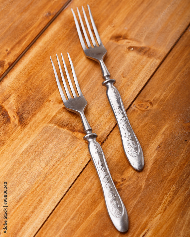 The forks on the wooden table The forks on the wooden table