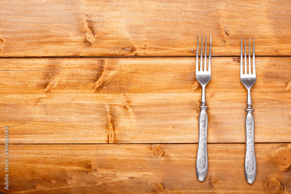 The forks on the wooden table The forks on the wooden table