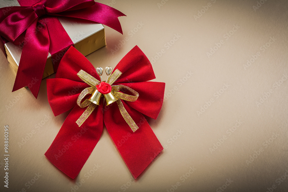 Packed giftbox bow on golden background holidays concept Packed giftbox bow on golden background holidays concept