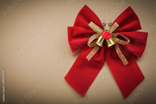 Red bow on golden background holidays concept
