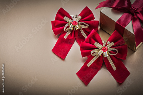 Wrapped present box with tied ribbon red bows holidays concept