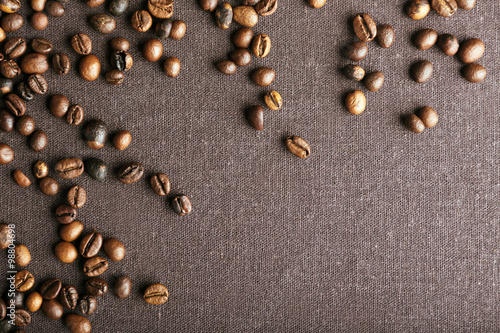 Roasted coffee beans on grey textile background