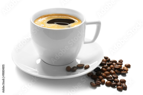 A cup of tasty drink and scattered coffee grains, isolated on white