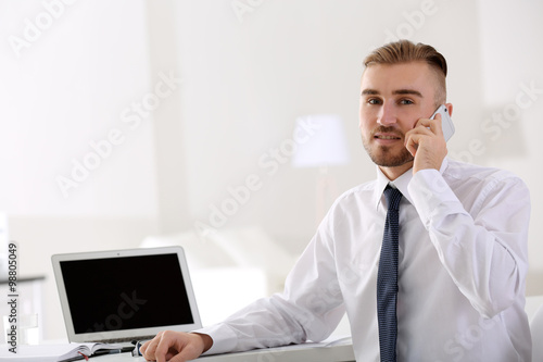 Businessman working with laptop in office