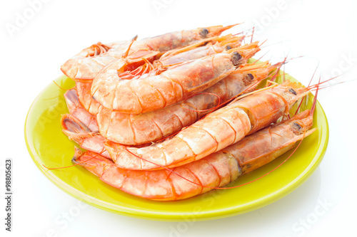 plate of raw prawns on white background