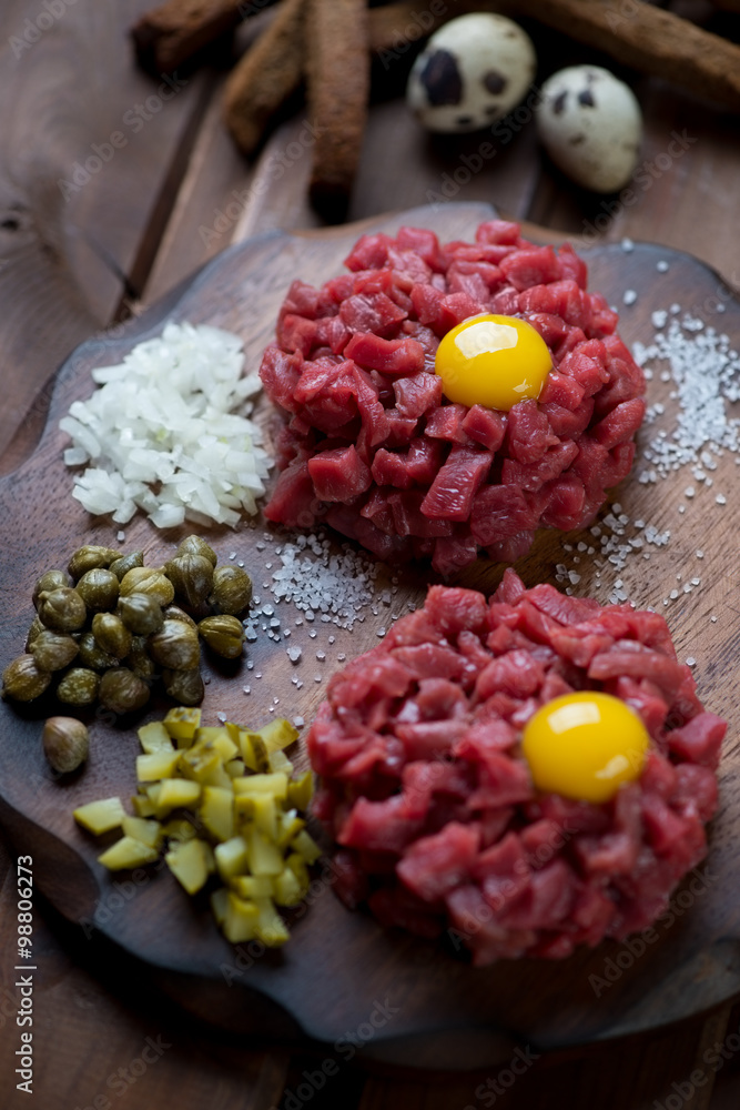 Close-up of two beef tartares with egg yolk, selective focus Close-up of two beef tartares with egg yolk, selective focus