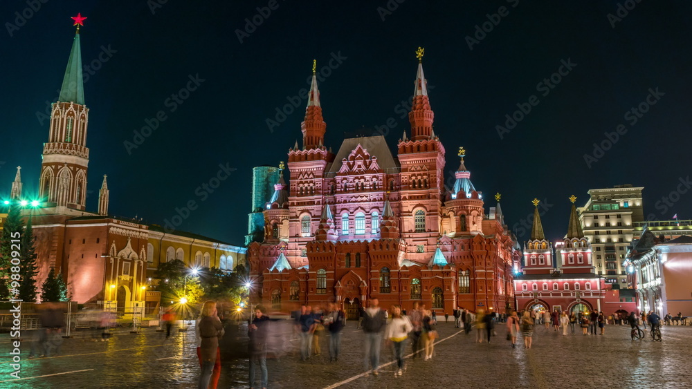 Illuminated State Historical Museum at Red Square at night in Moscow, Russia. Blurred people, hyperlapse, black sky at the background