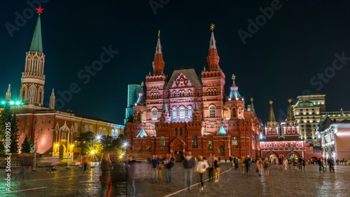 Illuminated State Historical Museum at Red Square at night in Moscow, Russia. Blurred people, hyperlapse, black sky at the background