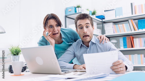Stressed couple checking bills photo