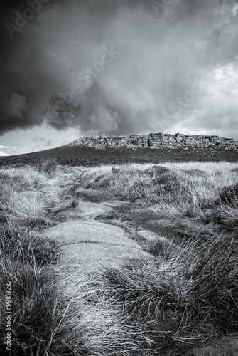 Monochrome storm clouds, hill and heather in the Peak District National Park