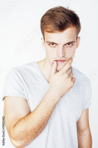 Canvas Print young handsome man on white background gesturing, pointing, posing emotional, cu