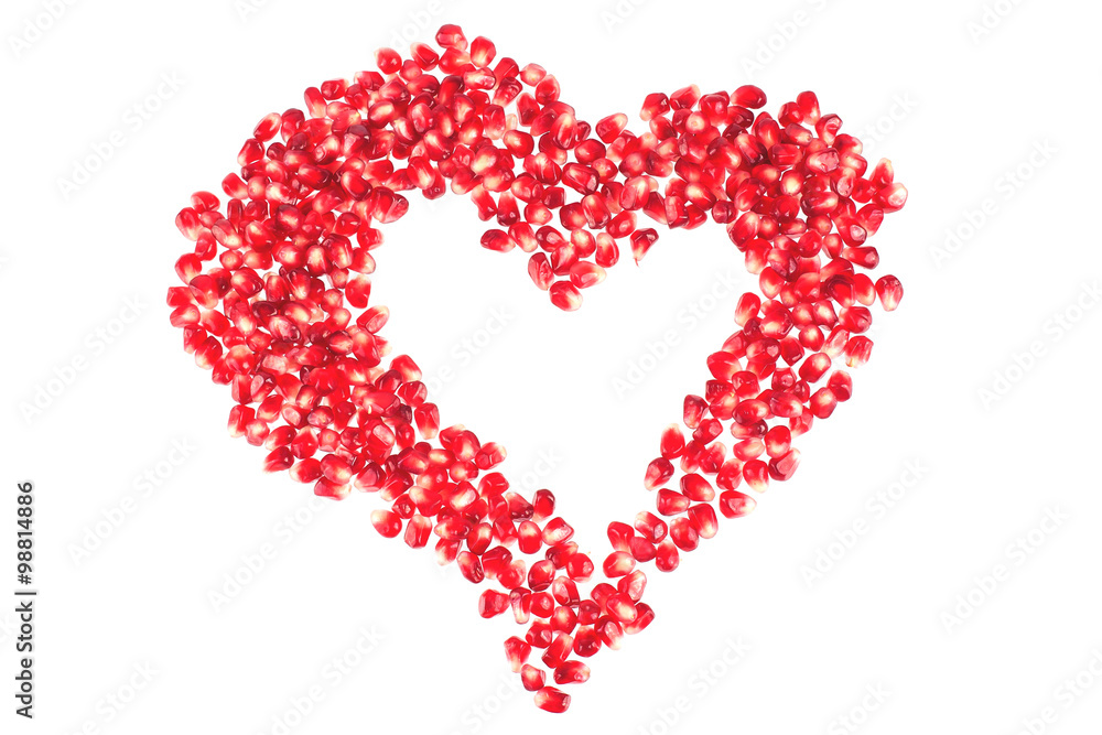 Valentine's heart shape made by pomegranate seeds (isolated on white)