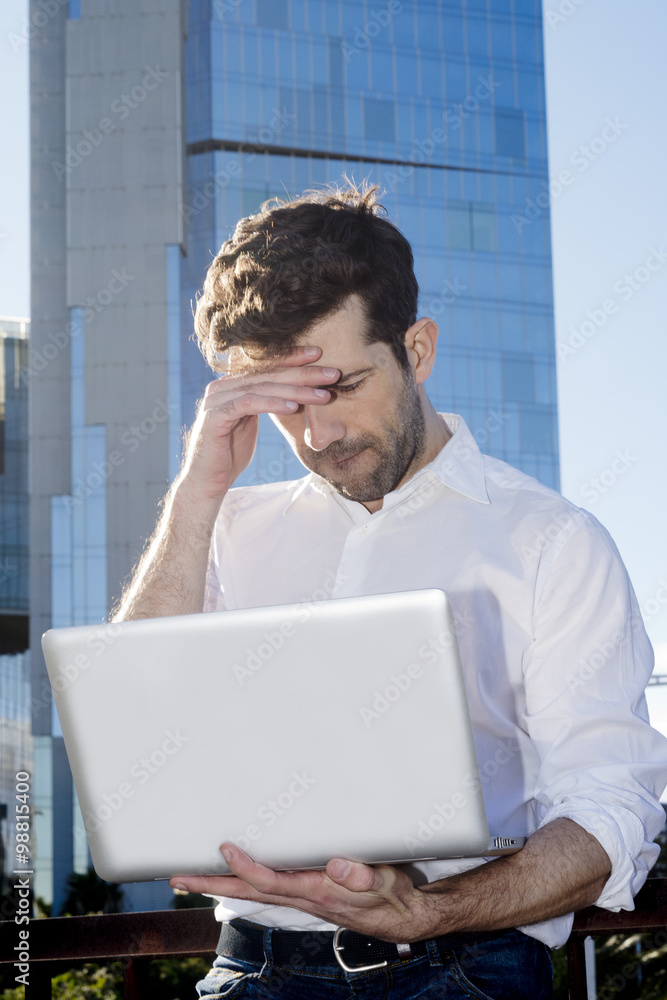 Man with laptop outdoors have problems Man with laptop outdoors have problems