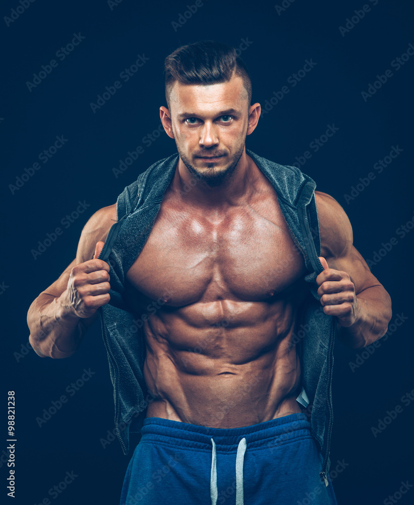 Fototapeta premium strong athletic man on black background