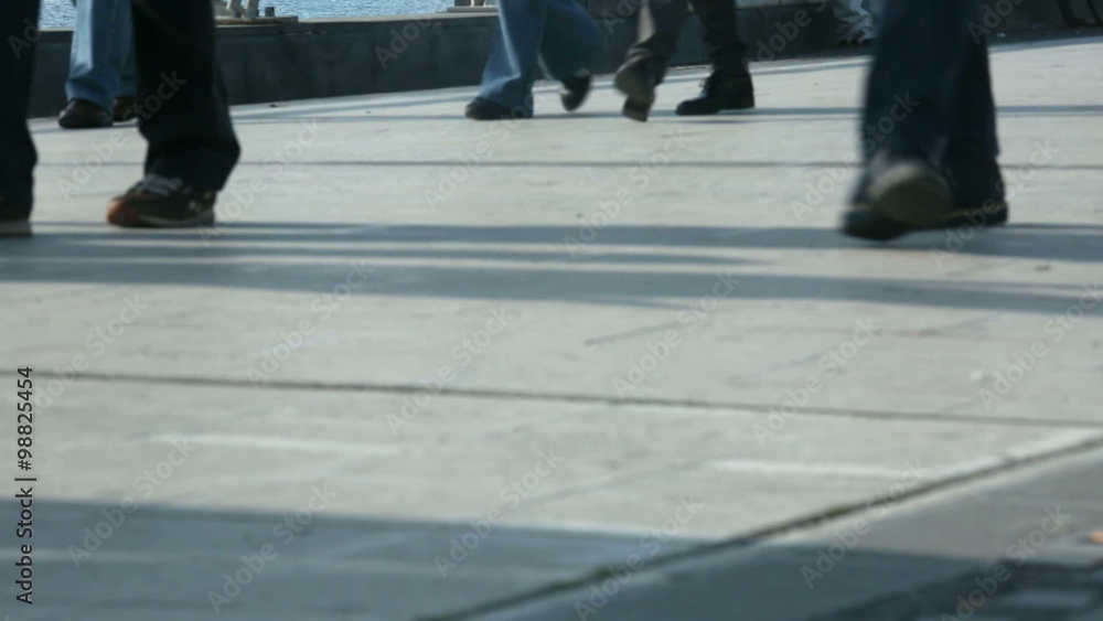 Pedestrians walking along the waterfront Pedestrians walking along the waterfront