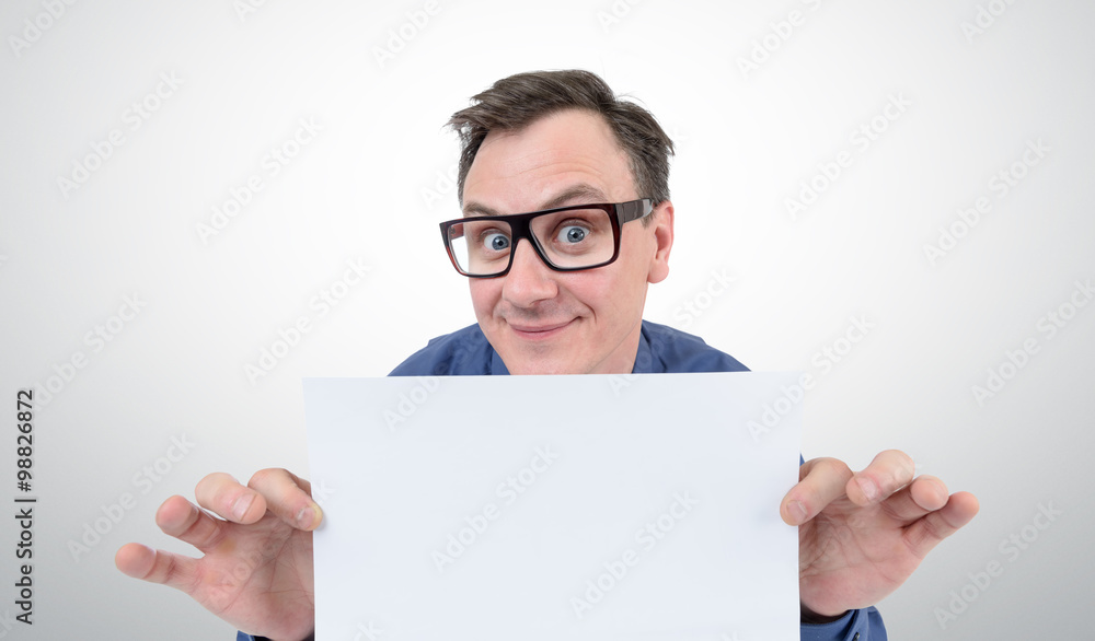 Happy businessman in glasses holding a white sheet of paper Happy businessman in glasses holding a white sheet of paper
