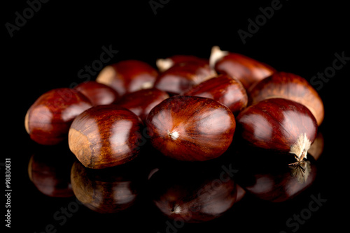 Chestnuts on a black reflective background