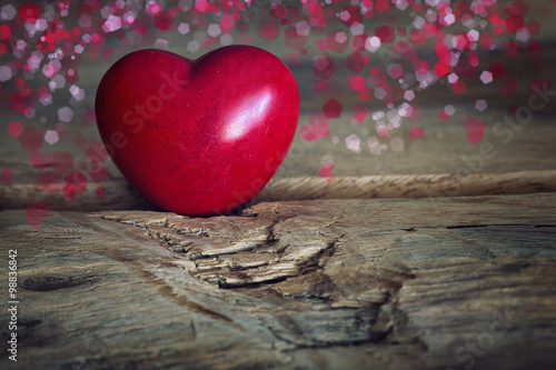 Red wooden heart on a wooden background. Valentines day card concept.