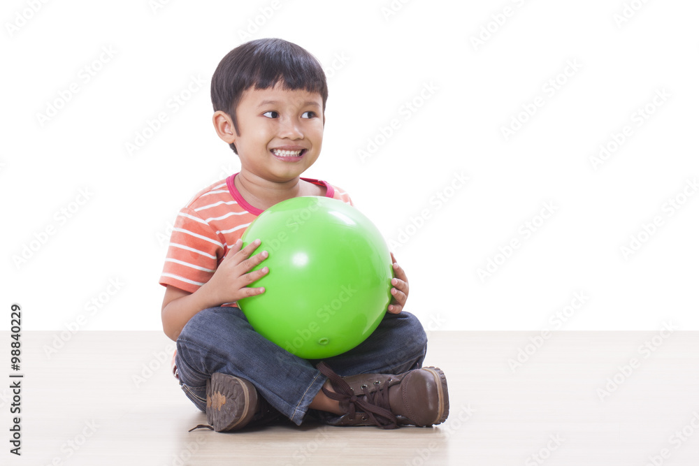 Fototapeta premium Little boy playing green ball 