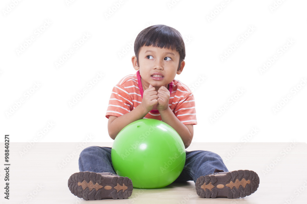 Fototapeta premium Little boy playing green ball
