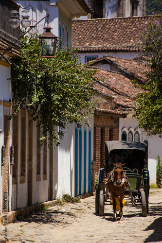 A wain in historical street with old church tower - Paraty - RJ