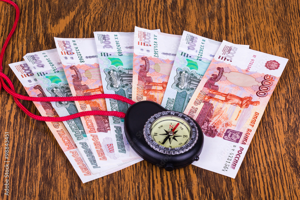 Money and Compass on the table Money and Compass on the table
