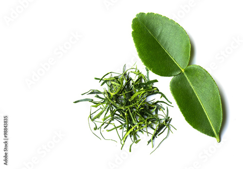 cutting into strips of kaffir lime leaf on white background