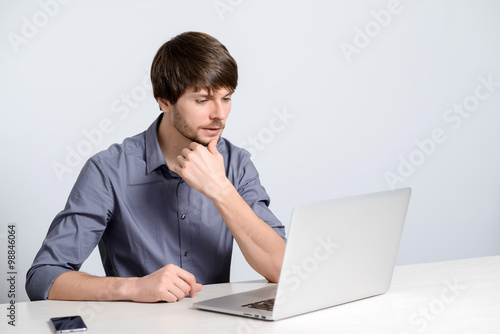 Young man working at laptop