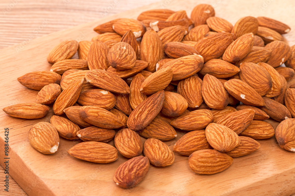 Fototapeta premium Almonds on a kitchen board