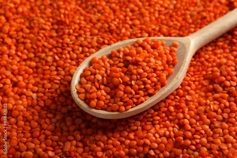 Red lentils in the wooden spoon Red lentils in the wooden spoon
