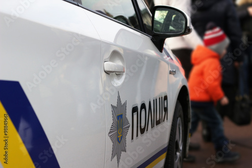 New police car, in front of people, ukrainian police reform