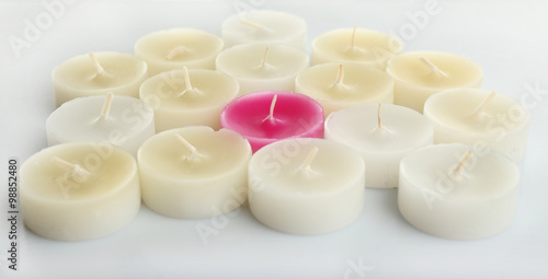 Pink and white small candles, isolated on white