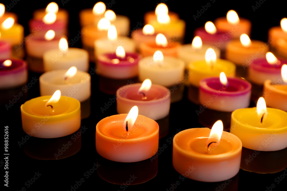 Many burning small candles on dark background Many burning small candles on dark background