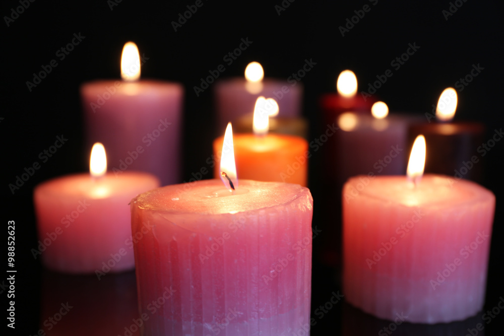 Many burning small candles on dark background, close-up Many burning small candles on dark background, close-up