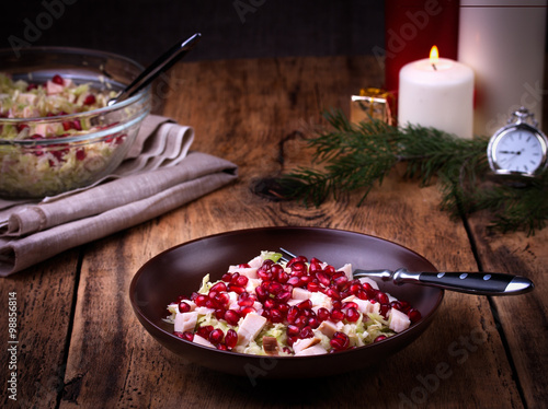 Healthy salad with pomegranate seeds, chicken and cabbage.