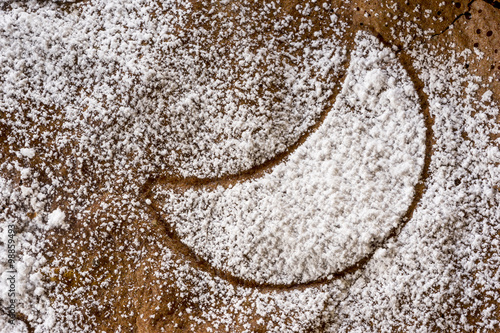 Crescent design in sprinkled icing sugar