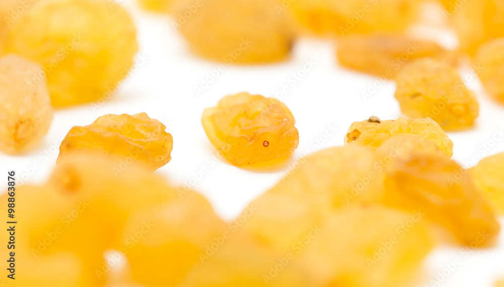 Golden raisins on a white background Golden raisins on a white background