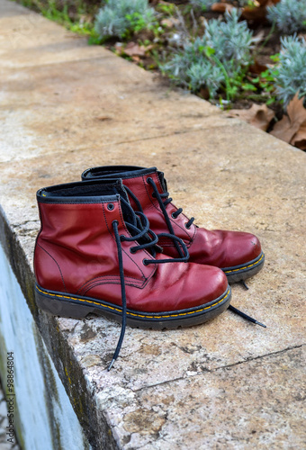 Pair of red boots abandoned on street