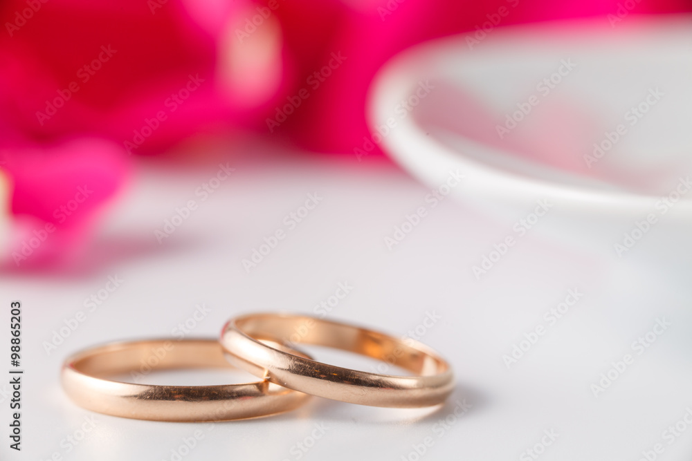 Golden wedding rings with rose petals Golden wedding rings with rose petals