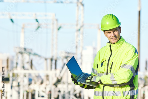 Service engineer working on laptop at electric power station