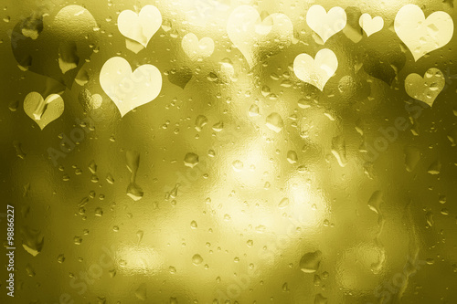 Glass textured shiny golden color Valentine's Day Heart shapes illustration background with droplet. Lovely textured Valentine Holidays greeting card copy space background.