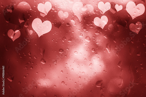 Glass textured shiny red color Valentine's Day Heart shapes illustration background with droplet. Lovely textured Valentine Holidays greeting card copy space background.
